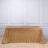 Gold sequin tablecloth draped over a table in a studio setting.