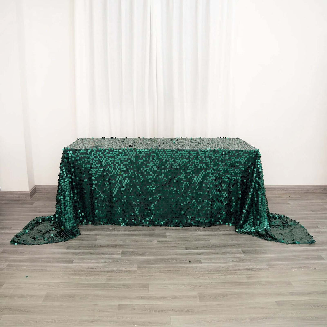 Green sequin tablecloth draped elegantly on a table.