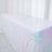 Iridescent sequin table cover on a white backdrop
