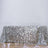 Silver sequin tablecloth on a plain background