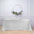 Silver sequin tablecloth draped elegantly on a table with floral decor.