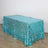 Blue sequin tablecloth on floor against white wall