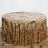 Gold sequin tablecloth draping over a round table.