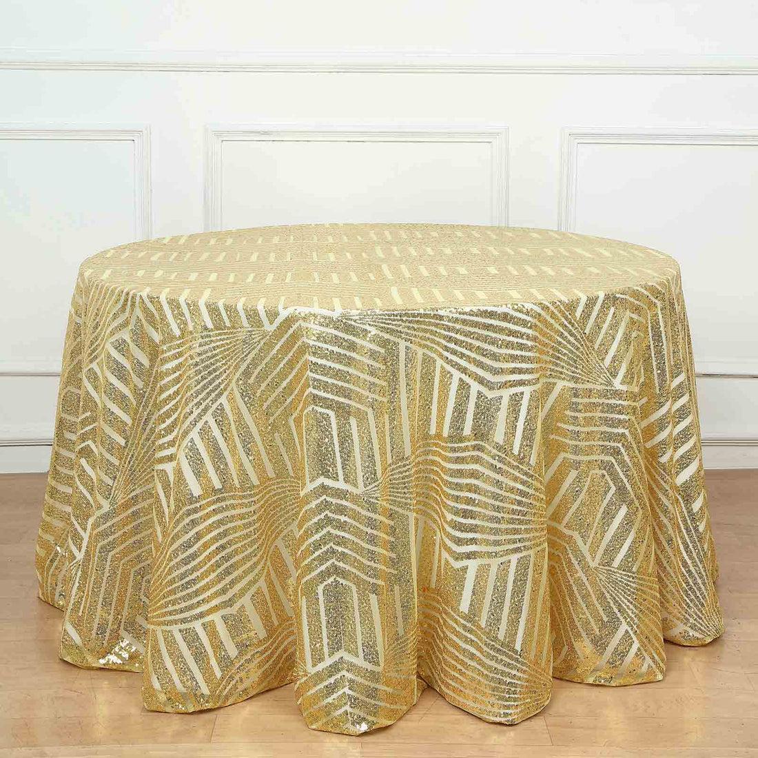 Gold geometric tablecloth on a round table in a bright setting.