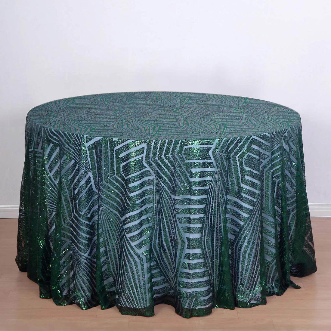 Round green tablecloth with a leaf pattern and sparkly design.