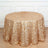 Gold sequin tablecloth with circular patterns on a round table.
