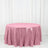 Pink sequin tablecloth on a round table against a white backdrop