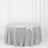 Silver sequin tablecloth on a round table against a white backdrop