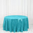 Turquoise sequin tablecloth on a round table against a white backdrop