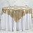Gold sequin tablecloth draped over a round table set for dining.