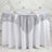 Round table with silver sequin tablecloth and elegant place settings.