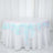 Round table covered with a shimmering iridescent sequin tablecloth.