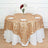 Gold polka dot tablecloth draped over a round table with white plates and flowers.