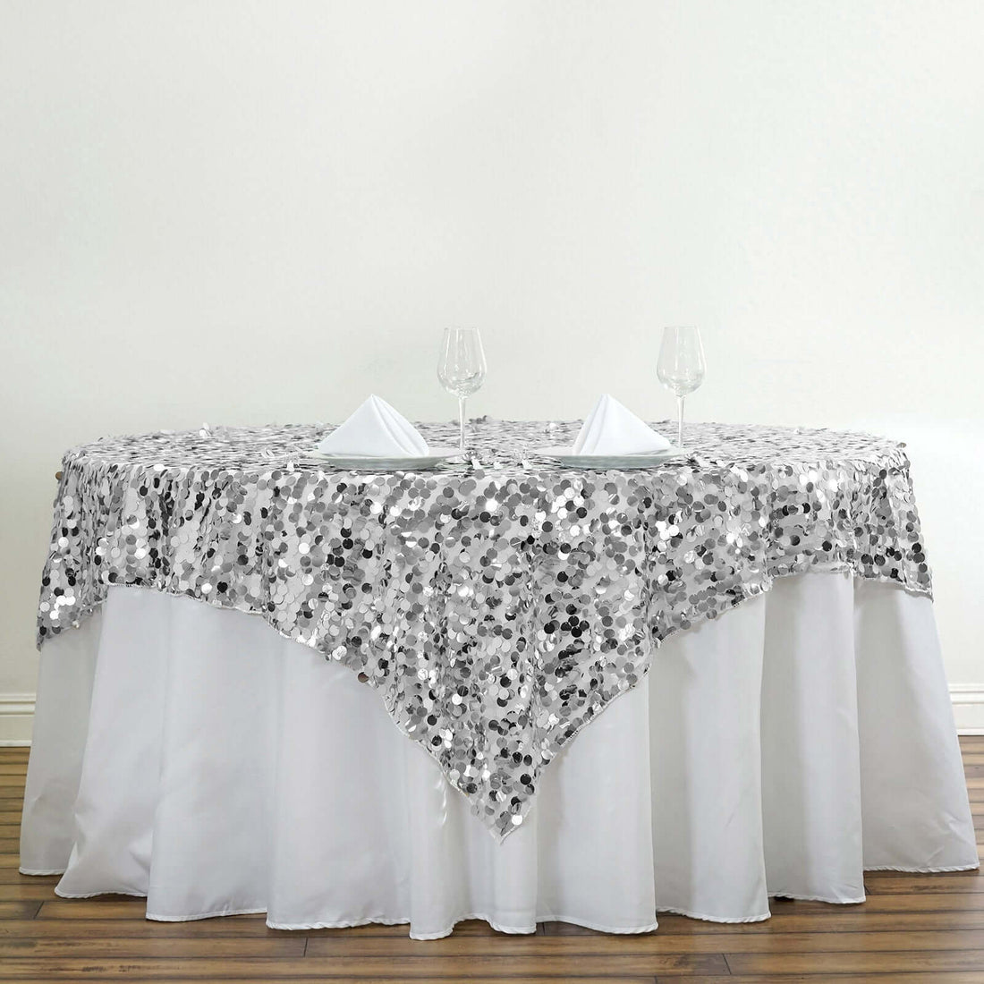 Silver sequin tablecloth draped elegantly over a white table