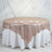 Rose gold sequin tablecloth draped elegantly on a round table with dinner plates.