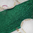 Green sequin table runner with elegant gold-trimmed plates and clear glasses.