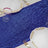 Blue sequin table runner with elegant plates and glassware set for dining.