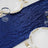 Navy sequin table runner with elegant plates and glasses set for dining.