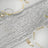 Silver sequin table runner with elegant gold-accented dinnerware.