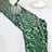Green sequin table runner on a white table setting.