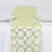 Green and silver circular pattern table runner on a white tablecloth #whtbkgd
