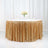 Gold sequin table skirt with elegant floral centerpiece.