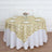 Round table with an elegant gold and cream floral tablecloth