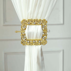 Gold decorative curtain tieback with ornate design and crystal accents.