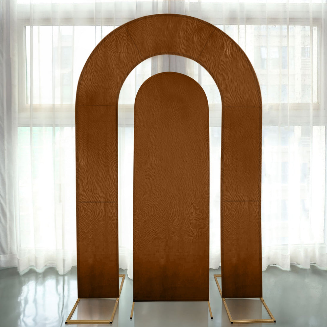Modern three-arch display backdrop in warm brown tones.