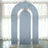 Gray arch backdrop with gold stands in a bright, airy space.