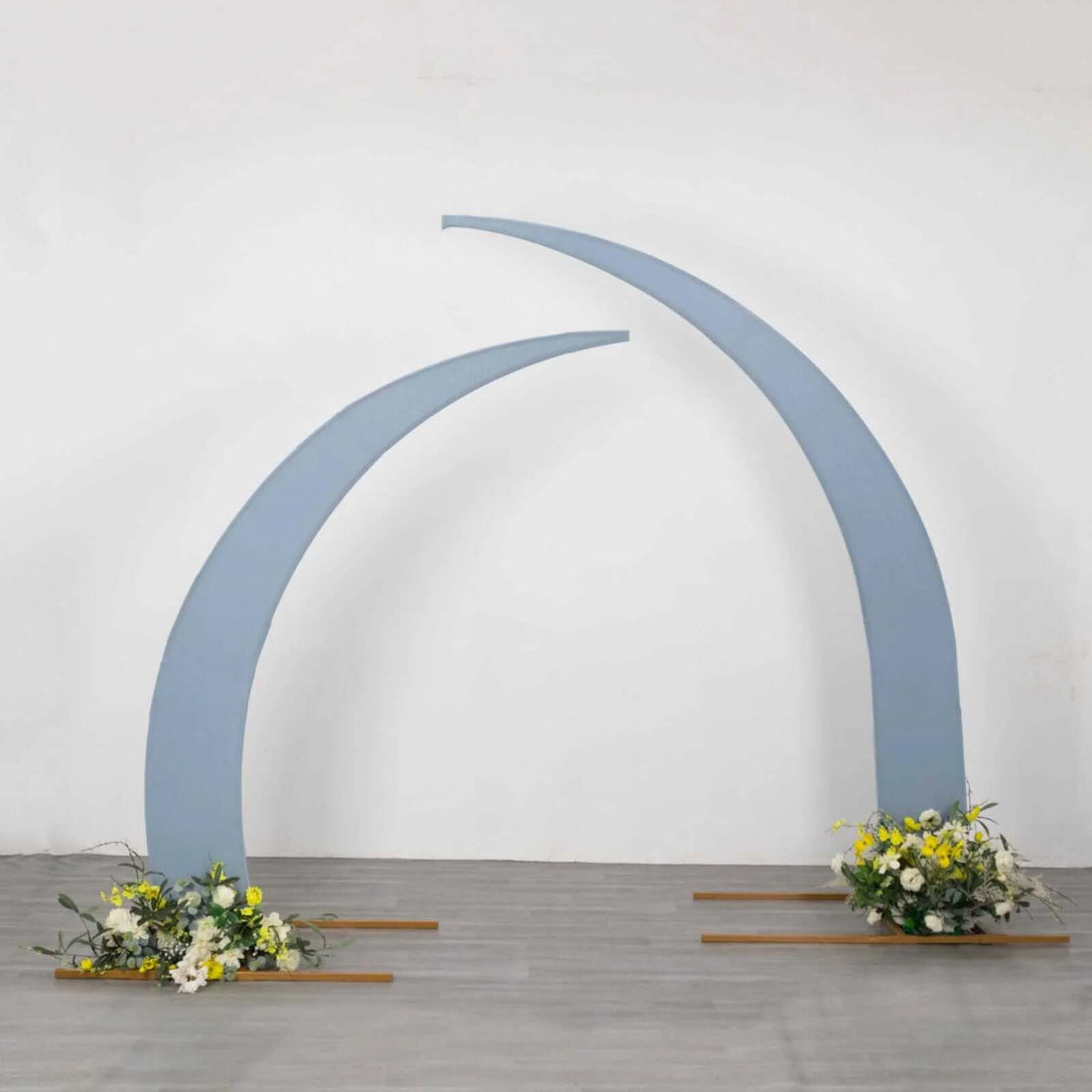 Blue curved arch with floral arrangements at the base.