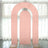 Pink arch backdrop display in a studio setting with sheer curtains.
