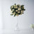 Elegant white rose bouquet in a clear glass vase.