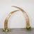 Gold crescent arch with flowers, perfect for weddings and events.