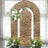 Gold sequin backdrop with floral arrangements for events and photo shoots.