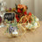 Geometric gold candle holders with flowers on a table setting.