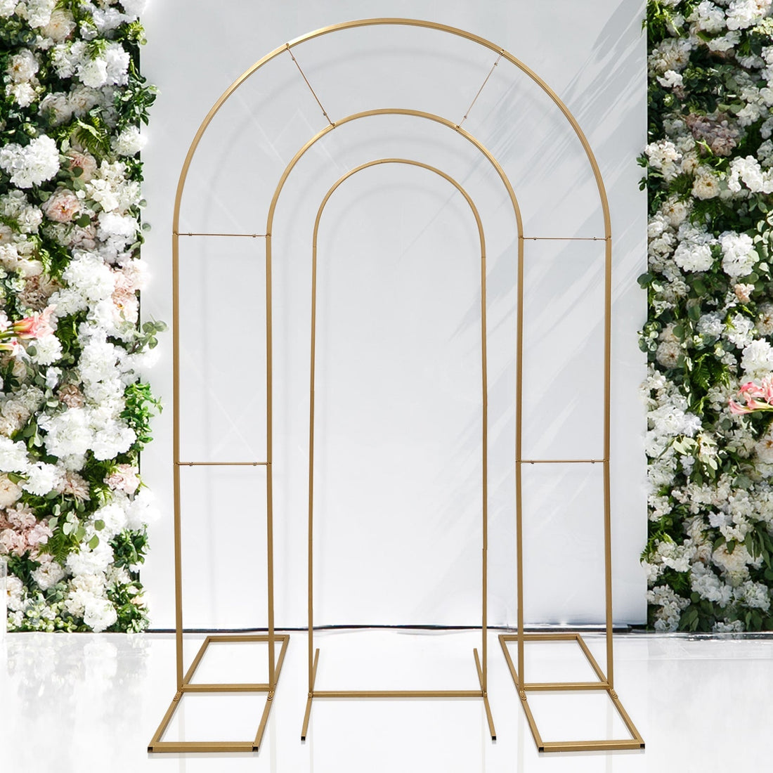 Gold metal arch backdrop for events and weddings. Elegant floral arrangement.