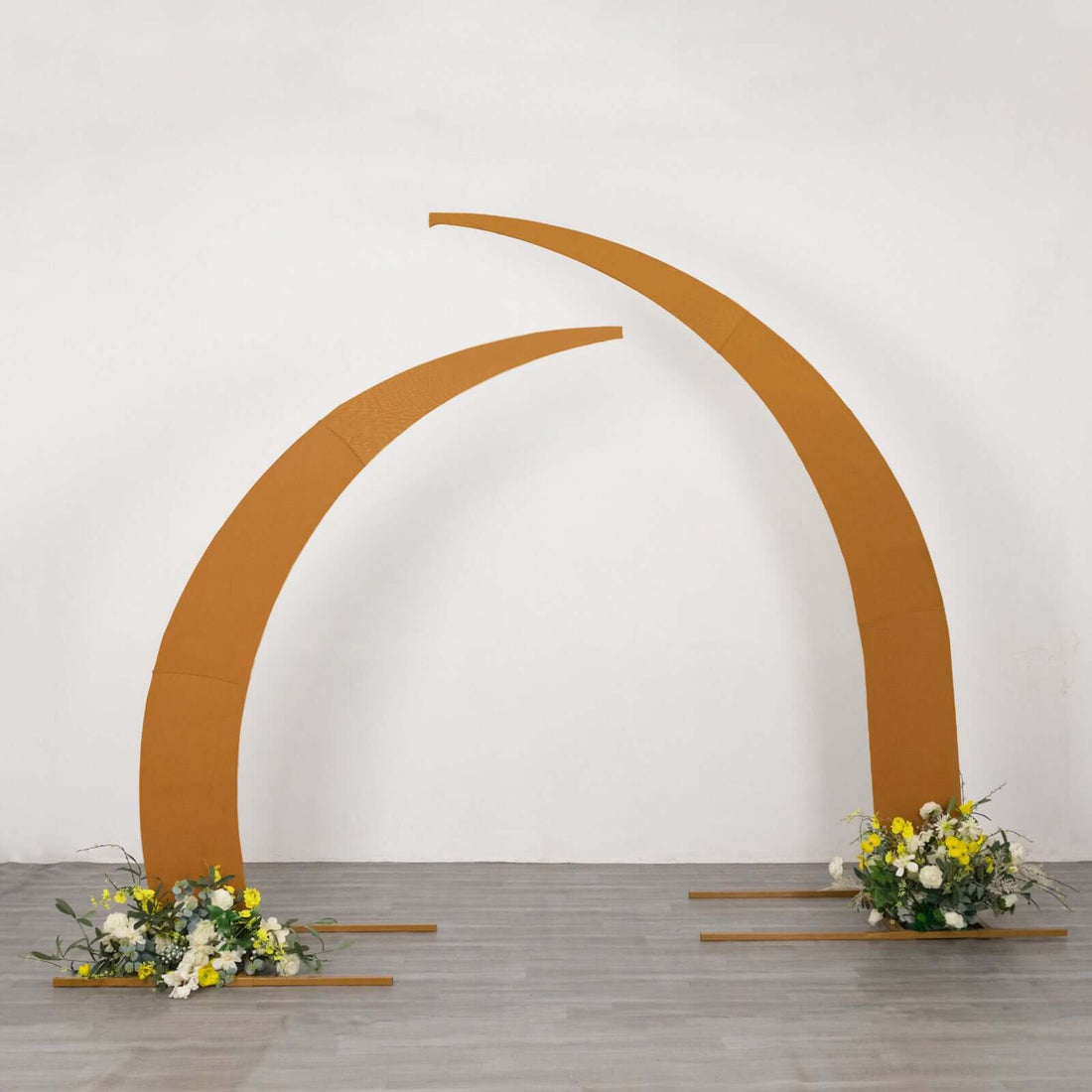 Curved metal arch with floral arrangements for events and weddings.