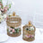 Gold decorative birdcages with floral arrangements on a table setting.