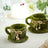 Moss-covered cups with twine and bead accents