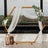 Wooden hexagon frame with draped fabric and floral decor, set in a scenic venue.