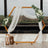 Wooden hexagon arch with white drapery and floral accents for weddings.