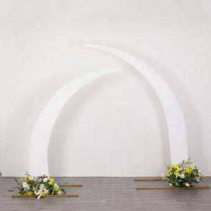 White curved arch with floral arrangements at the base