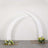 White curved arch with floral arrangements at the base