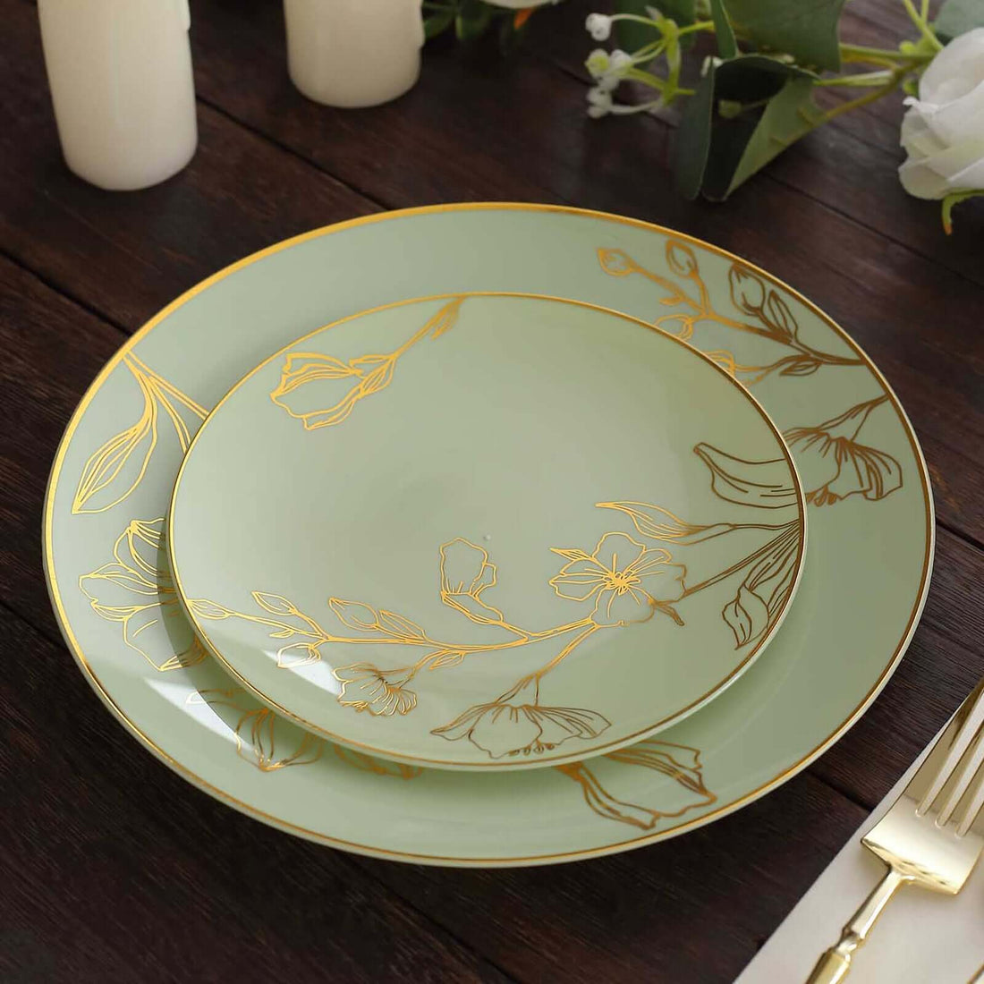 Elegant green dinner plates with gold floral design, arranged on a wooden table.