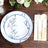 Elegant floral dinnerware set with plates, cutlery, and napkin on wooden table.