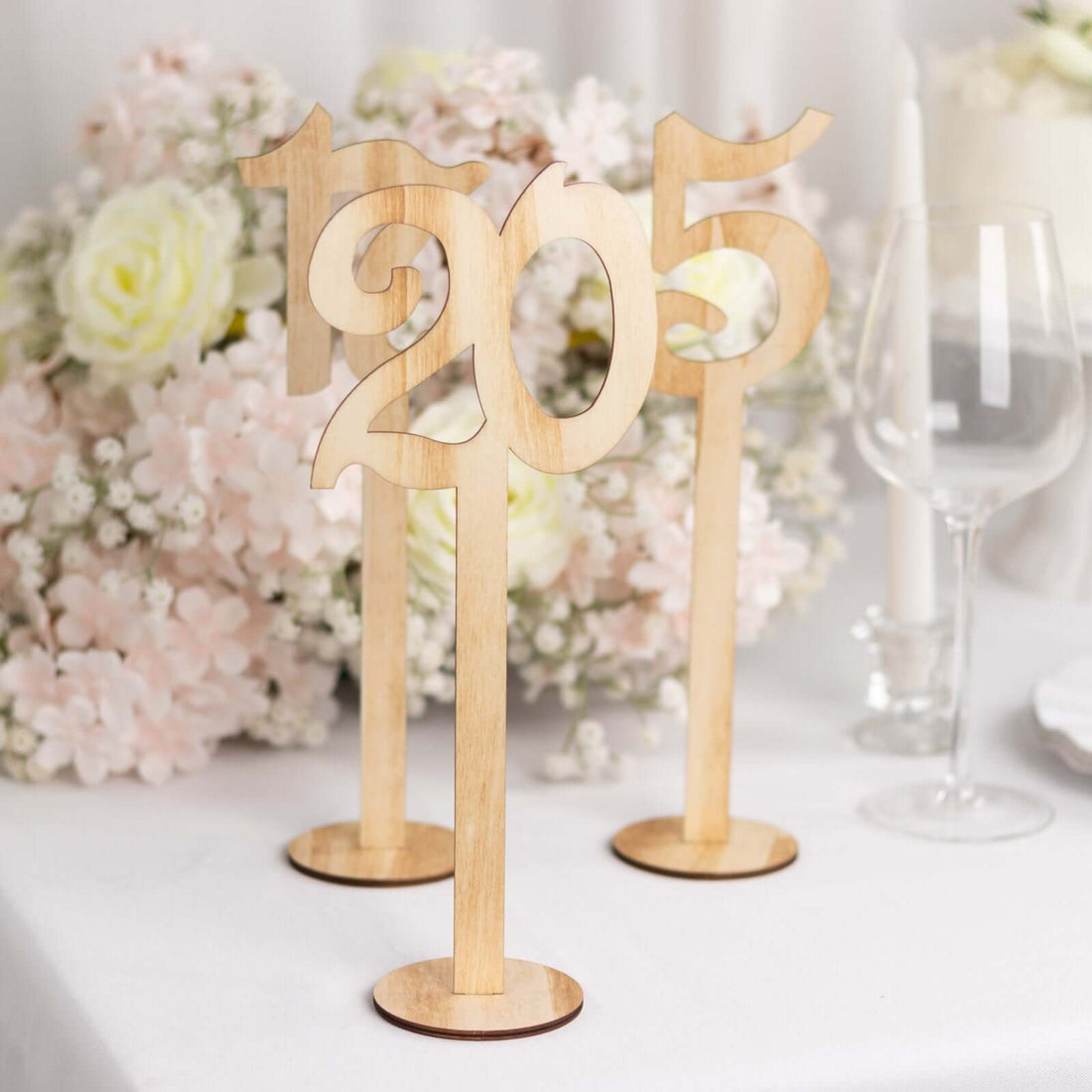 Wooden table numbers 1205 with a floral backdrop.