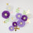Colorful paper flowers with butterflies and leaves on a white background.