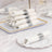 Elegant white napkins with silver accents arranged on a decorative plate.