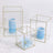 Geometric glass candle holders with blue candles and flowers